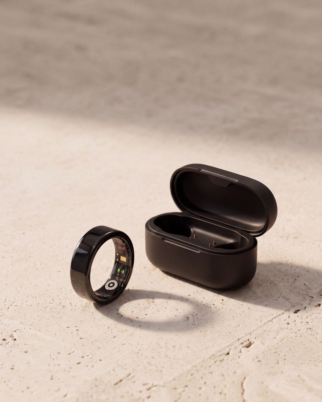 [Black] Lumo Ring in black with charging case on stone