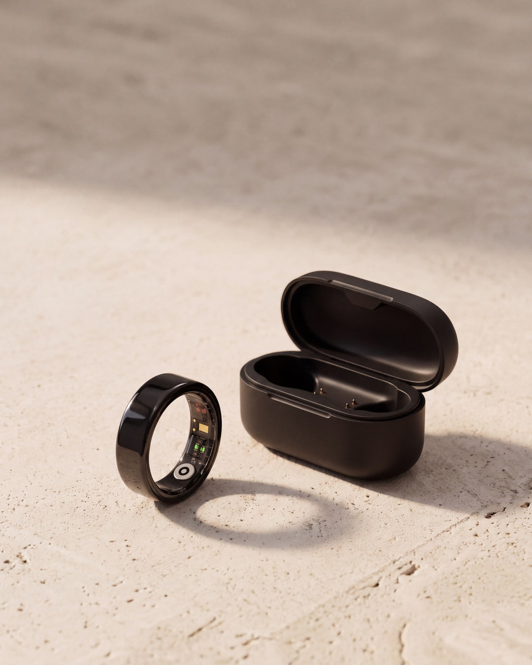 [Black] Lumo Ring in black with charging case on stone